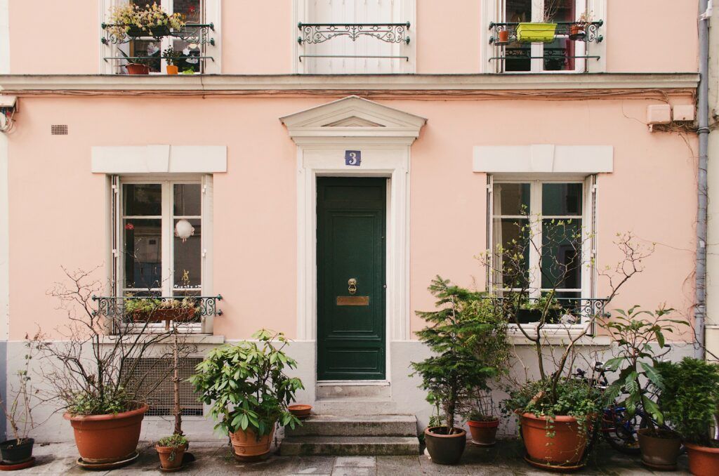 Apartment entrance with fresh paint and potted plants, showing how curb appeal boosts rental value.