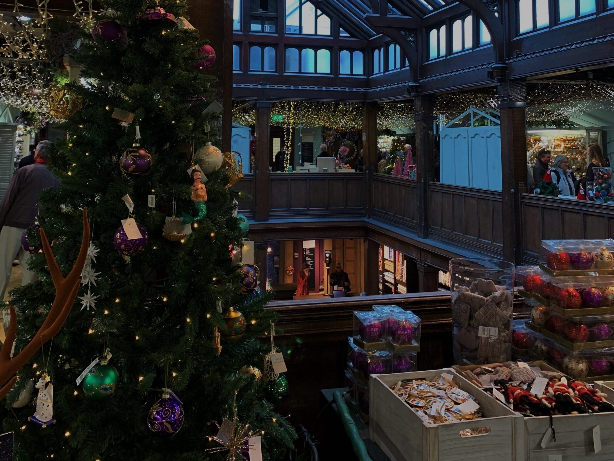 Indoor Christmas market with decorated tree, festive lights, and holiday stalls in Spain
