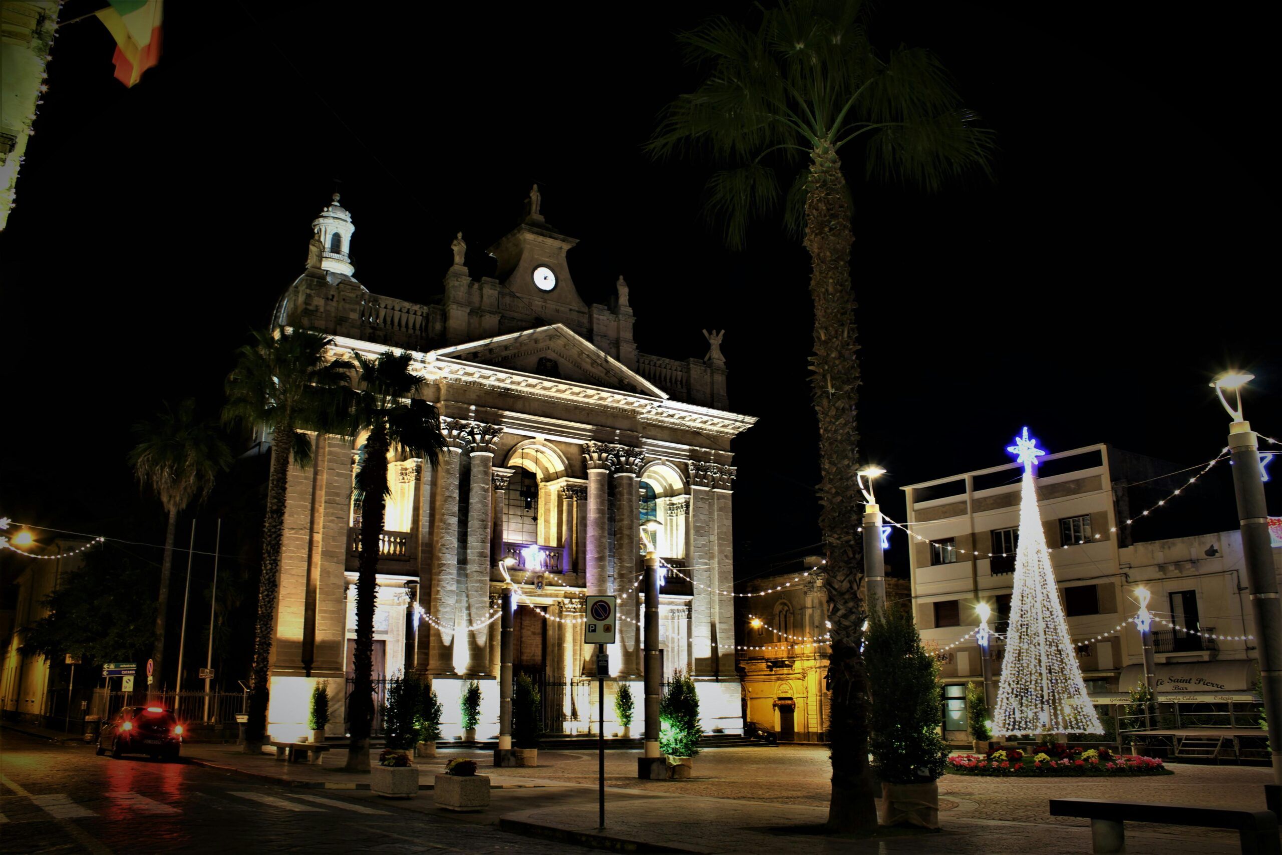 Christmas lights and decorated church facade with holiday tree in Valencia Spain