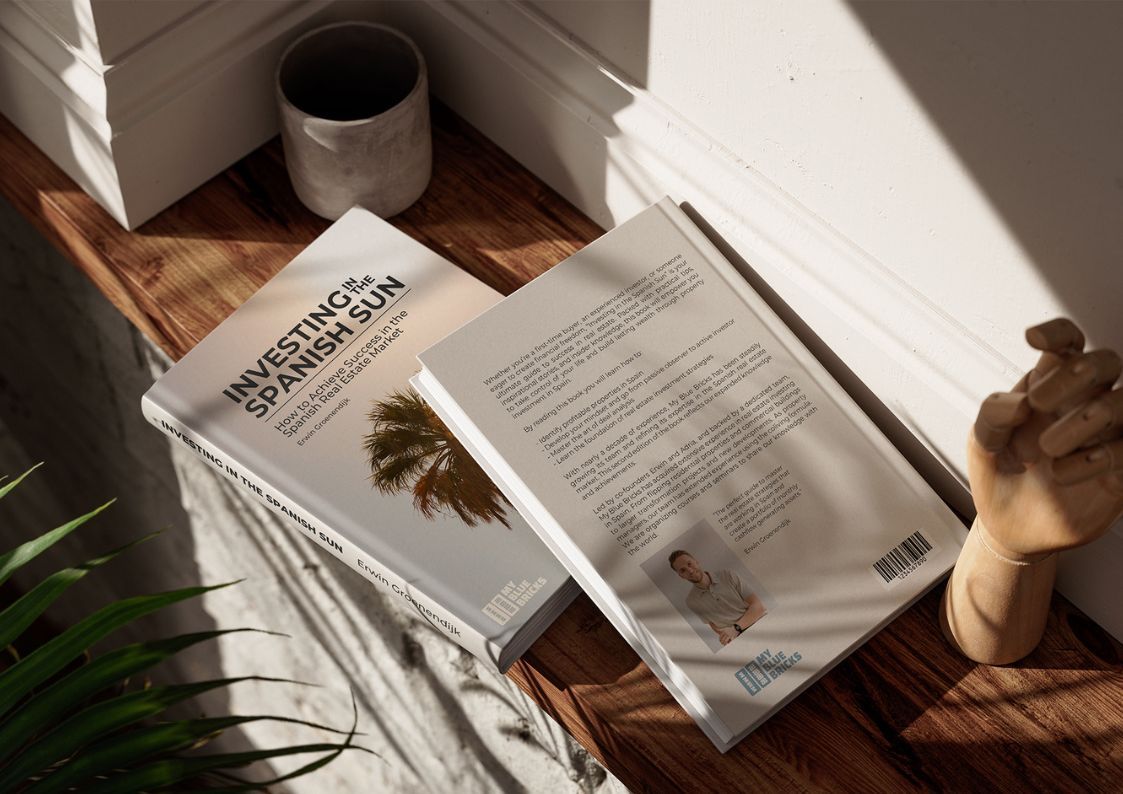 Copy of Investing in the Spanish Sun book on a wooden table in natural light, a guide to property investment in Spain.
