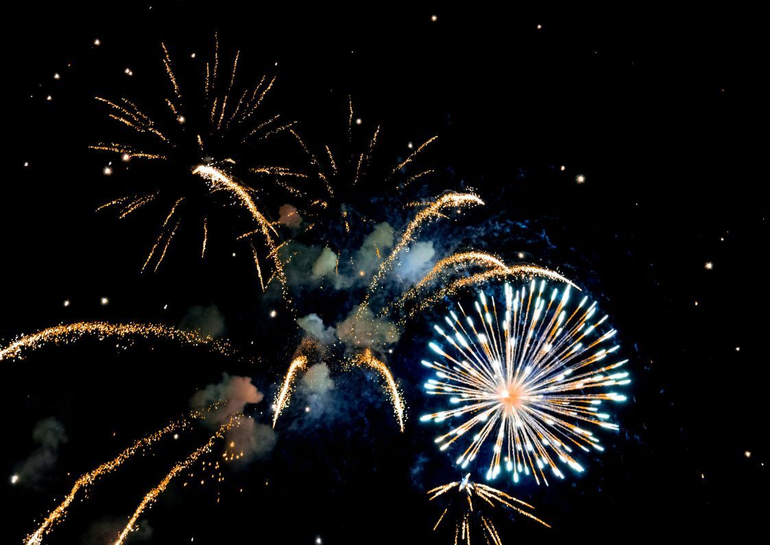 Colorful fireworks lighting up the night sky during New Year celebrations.