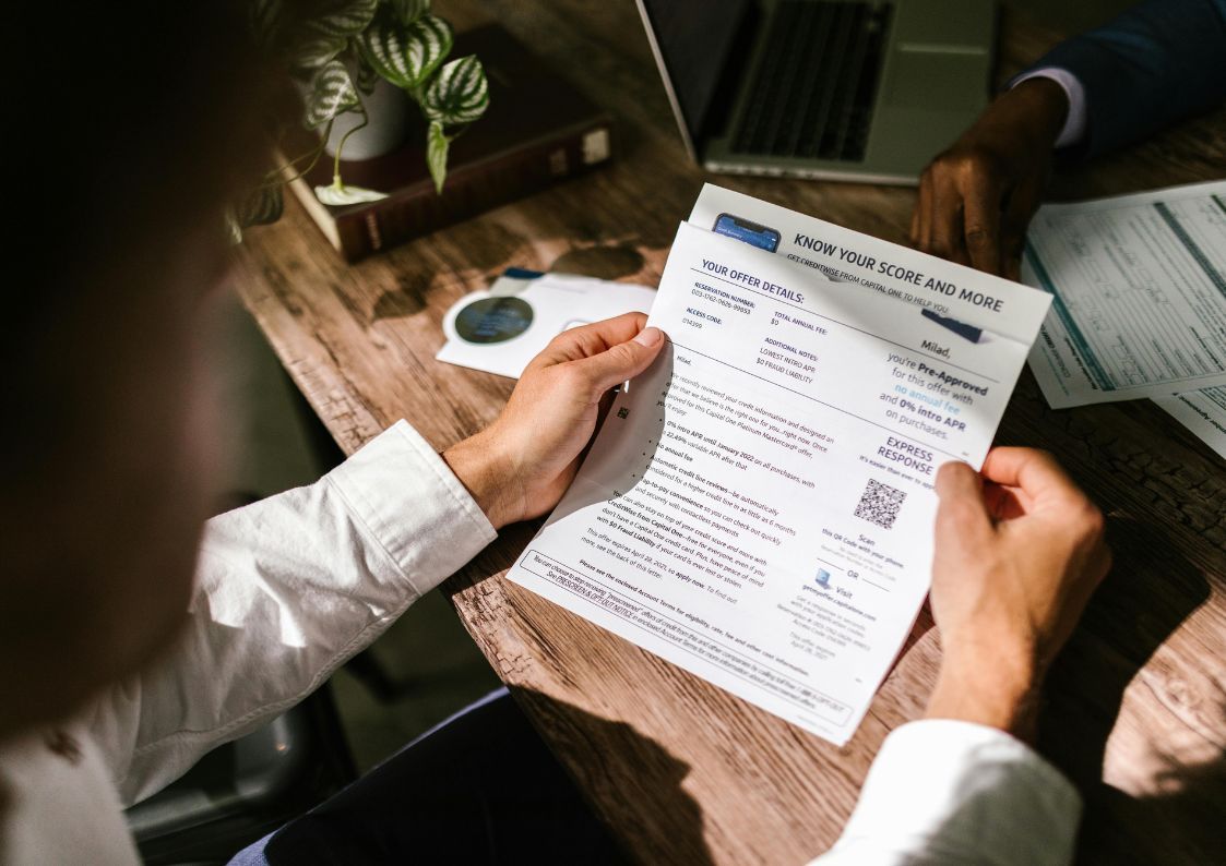 Buyer reviewing a mortgage pre-approval document during a property financing meeting.