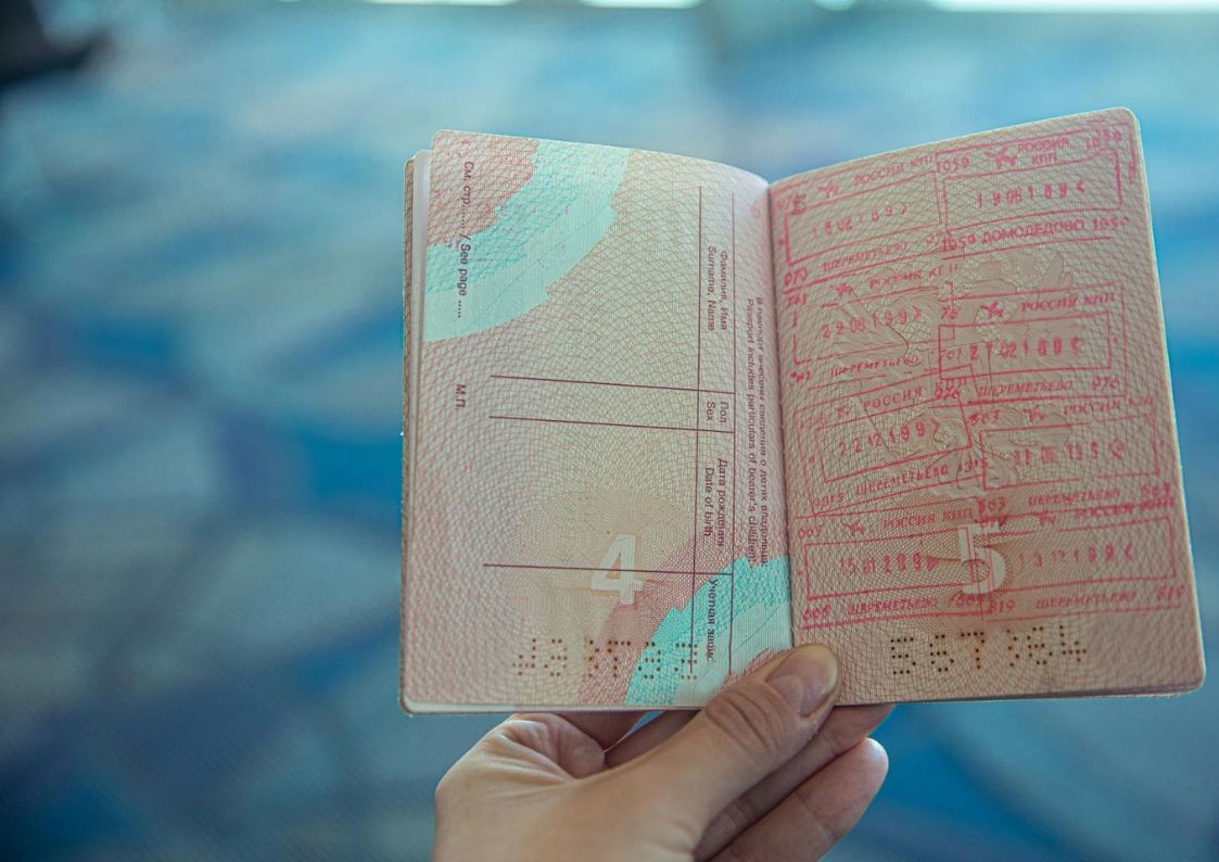 Open passport with multiple visa stamps, illustrating international travel and Spanish residency applications