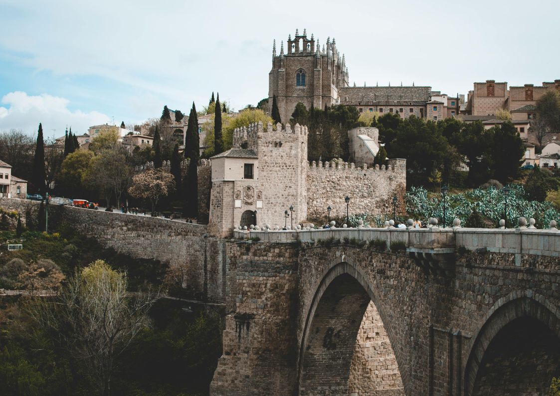 Historic stone bridge and old town architecture in Spain, highlighting timeless charm and cultural heritage.